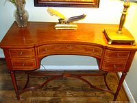 Front view showing bows and inlay pattern on top, with decorative objects to illustrate scale