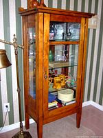 Front and left side view of cabinet with door closed showing overall design and condition