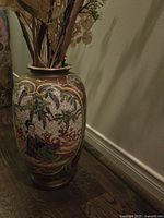 Full view of the Satsuma floor vase showing its form and decorative pattern with floral and figure motifs.