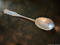 Photo of Victorian silver plated stuffing spoon showing detailed King’s pattern handle and scalloped bowl.