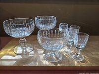 Photo showing 3 sherbets and 4 liqueur glasses, clear Waterford crystal with vertical diamond cuts and textured stems.