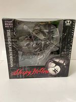 Front view of the original box with plastic window showing parts of the figures inside, branded 'Sleepy Hollow The Headless Horseman Deluxe 3-piece box set'.