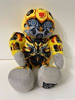 Front view of 16 inch Bumblebee plush bear with robotic face and Autobot symbols