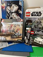 Boxes of Lego Star Wars sets 75326 and 75234 shown with some loose baseplates underneath