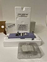 Model car displayed in original foam packaging showing front and side details.