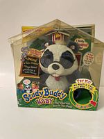 Front view of Study Buddy Koby plush toy in original packaging with visible branding and educational features.