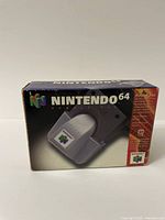 Front view of Nintendo 64 Rumble Pak box showing product image and branding.