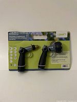 Full packaging image showing two Orbit metal thumb-controlled watering spray nozzles in blister pack