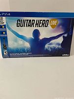 Front side of the sealed Guitar Hero Live for PS4 box showing the main artwork and branding.