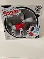Front view of the sealed Squeakee Spotty the Dalmatian balloon dog toy in original packaging showing the toy and box design.