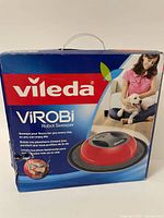 Front of the box showing Vileda Virobi Robot Sweeper branding and product image with a woman and dog.