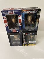 Four boxed vinyl figures arranged in two rows showing front of packaging for title identification.