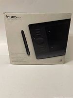 Box front showing Wacom Intuos 5 Touch small pen tablet and stylus pen image with professional branding.