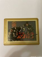 Front view of the Wayne Gretzky hockey card with autograph showing player in Los Angeles Kings uniform and red Japanese characters in background.