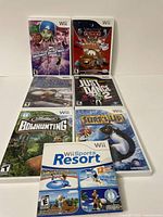 All seven Wii game titles displayed in original cases with cover art and booklets visible inside. Games include various genres such as sports, dance, racing, and kids' animation.