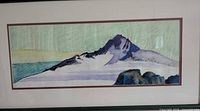 Watercolor painting showing a panoramic view of a mountain peak with snow and rocky features, framed and matted.