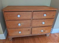 Front view showing six drawers and white ceramic knobs