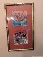 Full framed batik artwork with two panels of coral and fish images in a bamboo-type frame