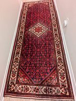 Full length view of runner showing red ground with floral pattern and cream floral border
