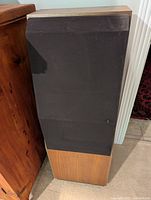 Single speaker front view with black fabric grille installed