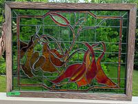 Full front view of stained glass panel showing entire abstract floral design and frame
