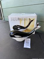 Front view showing whale figurine with box behind