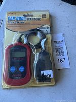 Photo of packaged Autel MS300 CAN OBDII MaxiScan scan tool showing the device, cable, and packaging with branding and product features.