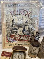 Punch magazine cover, English bluing solution bottle, Twissors scissors package and small clock.