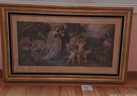 Front view of large framed photogravure print depicting a classical romantic scene with a man, woman, and cherubs, in gold-tone ornate frame, measuring approx. 21x35 inches