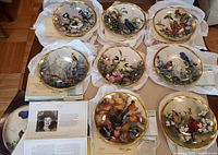 Nine decorative Lenox plates from The Nature's Collage Collection with artworks of birds and flowers, displayed with paperwork.