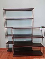 Wide view showing both shelving units side by side against a wall