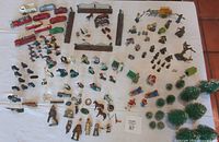 Overhead view showing entire lot of toy cars, figurines, trees, fences and accessories.