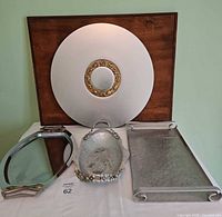 Three vintage trays displayed: round zodiac tray, Kromex deco tray, hammered floral tray