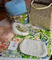 Full lot showing hats, handbags, skirt, and hat box on floral cloth