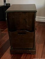 Front view showing the open magazine rack section with handle cutout and base molding detail.