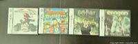 Photo showing four Nintendo DS game cases with cover art for Mario Kart DS, Professor Layton and the Curious Village, Harry Potter and the Half-Blood Prince, and Eregon