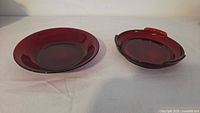 Two Royal Ruby red plates on white backdrop
