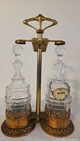 Full view of copper & brass tantalus with two glass decanters and stoppers