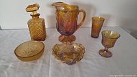 All six iridescent gold carnival glass pieces displayed