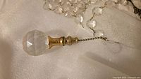 Faceted crystal ball drop with brass finial and octagonal crystal strand