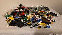 Overall pile of assorted LEGO pieces on white surface