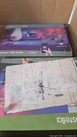 Two Novostella Smart LED Bulb boxes and misc card inside shipping carton