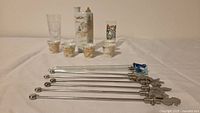 Full lot showing stirrers, shot glasses, sake bottle, cups
