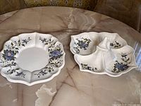 Photo of the Italian antipasto platter and matching serving plate placed on a marble table showing the overall look and composition