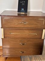 Full frontal view of the vintage walnut high boy dresser showing all four drawers and brass hardware details.