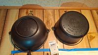 Two cast iron cookware pieces showing bottoms of both items