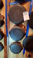 Three skillets arranged vertically showing backs with Griswold logo and stamped size numbers