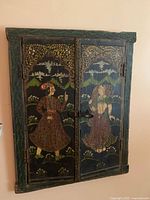 Front view of wood wall box with painted panels showing a man and woman in traditional attire and primitive latch.