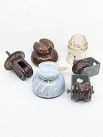 All six antique conductor insulators displayed together showing various styles and materials including ceramic and glass