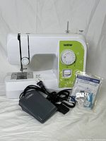 Brother JX1714 sewing machine with power cord, foot pedal, and sealed accessory bag in the original box.